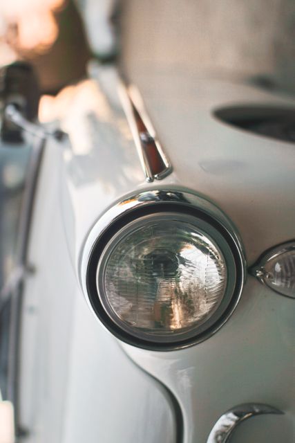 Showing detailed classic car headlight, perfect for illustrating vintage automotive design, retro theme, classic car enthusiasts' content, or advertising auto restorations.
