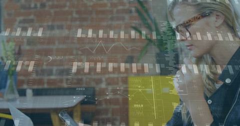 Businesswoman Analyzing Financial Charts on Laptop Screen