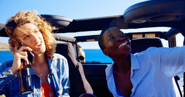 Diverse friends enjoying road trip in convertible car by the sea - Download Free Stock Images Pikwizard.com