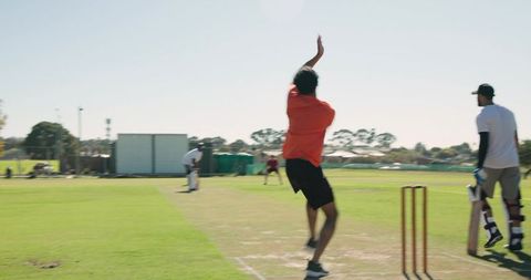 Asian bowler marking run-up and consulting umpire before sprinting into fast bowling