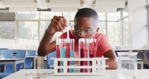 African American Boy Conducting Scientific Experiment with Test Tubes