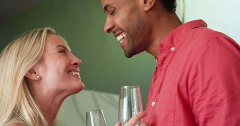 Happy Couple Celebrating with Champagne at Home Gathering