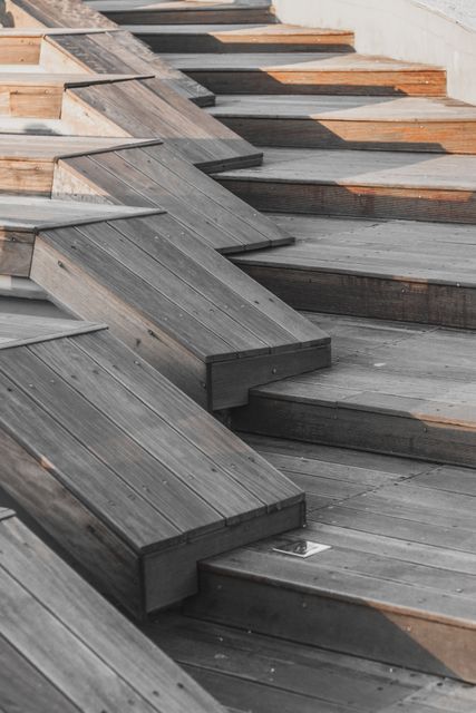Abstract wooden steps with geometric design can be used in modern architecture presentations, urban development projects, landscaping ideas, and artistic design portfolios. The image emphasizes contemporary design, symmetry, and functional outdoor structures.