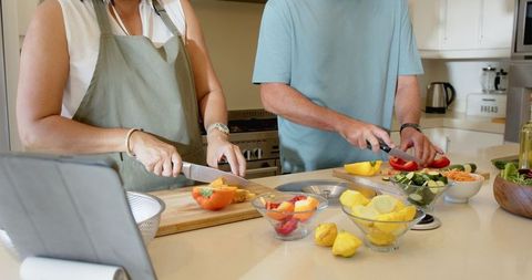 Diverse Couple Preparing Meal with Fresh Vegetables in Modern Kitchen