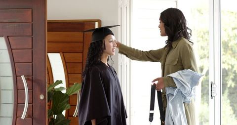 Graduate Celebrating Achievement at Home with Family