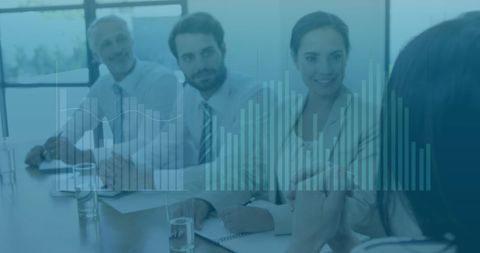 Financial Data Overlaid on Business Team in Conference