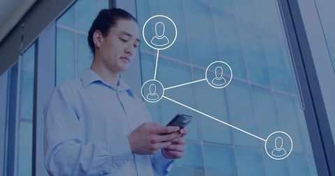 Asian businessman holding smartphone tapping screen by glass office wall with network icons