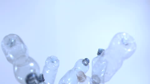 Falling Small Plastic Bottles in Super Slow Motion Studio Shot
