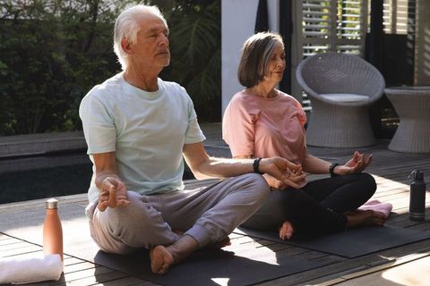 Senior Couple Enjoying Mindful Outdoor Meditation Together