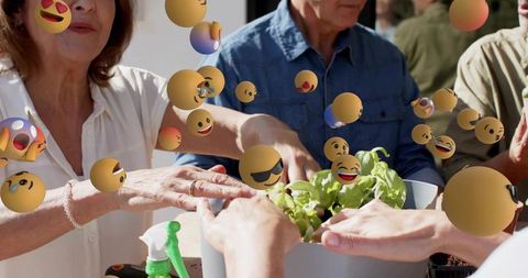 Multigenerational adults tending basil planter together with floating emoji reactions