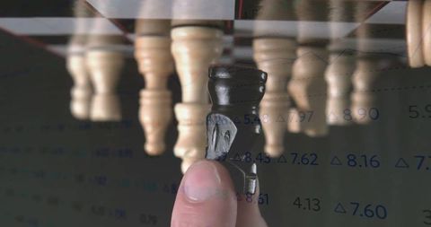 Hand Moving Knight Piece with Financial Data Overlay