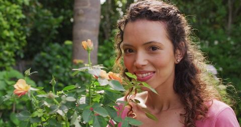 Smiling Woman Enjoying Rose Scent in Vibrant Garden - Download Free Stock Images Pikwizard.com