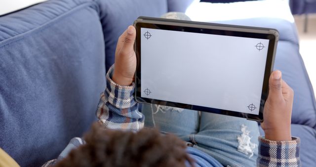 Child Holding Tablet with Blank Screen Mockup Relaxing on Couch - Download Free Stock Images Pikwizard.com