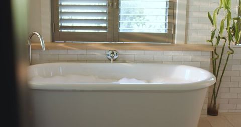 Luxurious Bathtub with Fresh Bubbles and Sunlit Ambiance
