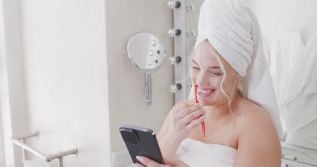 Smiling Woman in Towel and Hair Wrap Using Smartphone in Bathroom - Download Free Stock Images Pikwizard.com