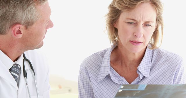 Doctor Discussing X-Ray Results with Concerned Female Patient - Download Free Stock Images Pikwizard.com