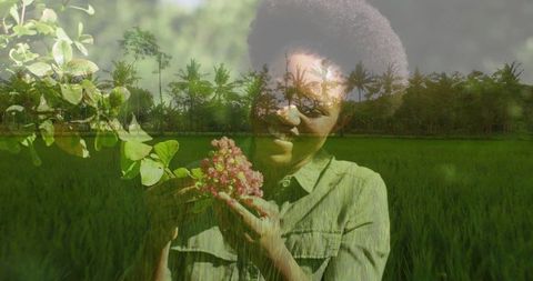 Woman Embracing Nature in Lush Paddy Field with Pinkish Berries