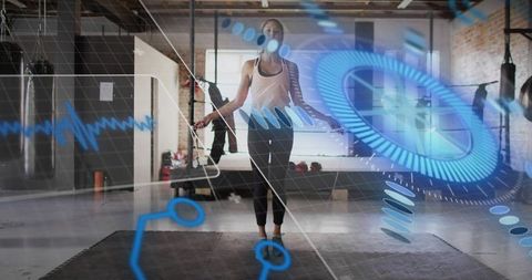 Woman jumping rope with futuristic fitness hud in industrial gym studio
