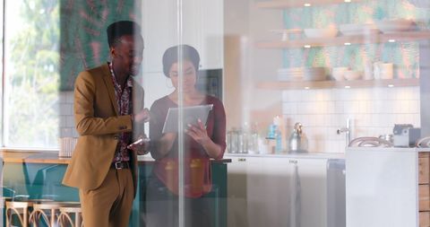 Business Team Discussing Strategy on Tablet in Modern Office