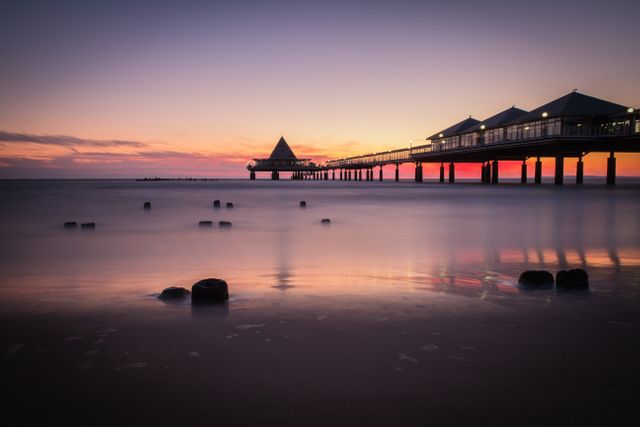 Scenic Pier at Sunset with Calm Ocean and Vibrant Sky - Download Free Stock Photos Pikwizard.com