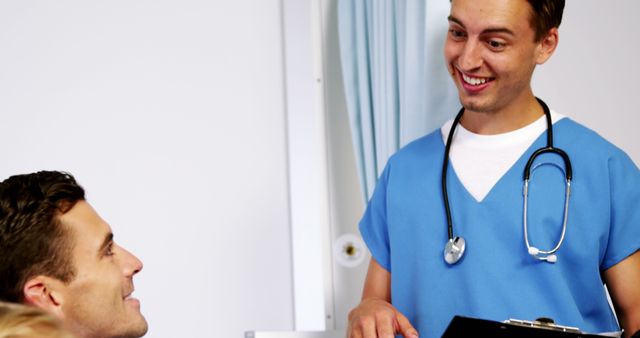 Male Nurse Smiling and Communicating with a Patient - Download Free Stock Images Pikwizard.com