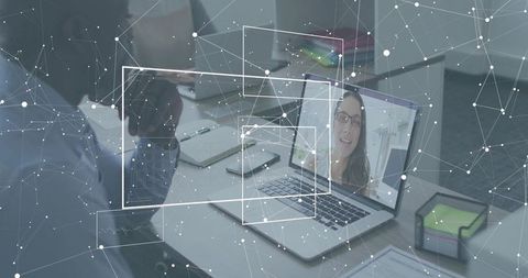 Hybrid team collaborating via laptop video call with digital network overlay and telepresence