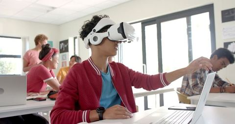 Teenager Engages with Virtual Reality Headset in Modern Classroom