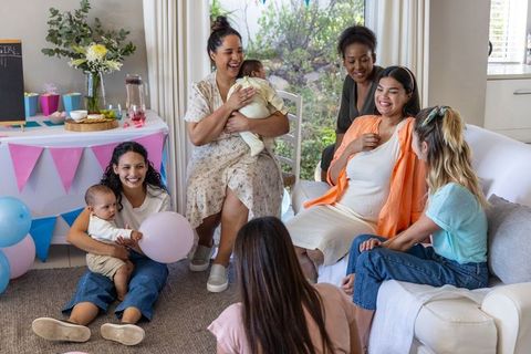 Joyful Baby Shower with Diverse Female Friends in Cozy Living Room