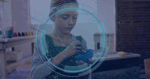 Young girl immersed in pottery art with ceramics and glazes