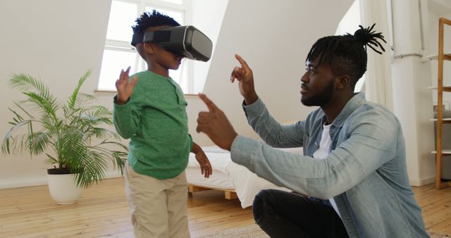 Father showing virtual reality to son indoors - Download Free Stock Images Pikwizard.com