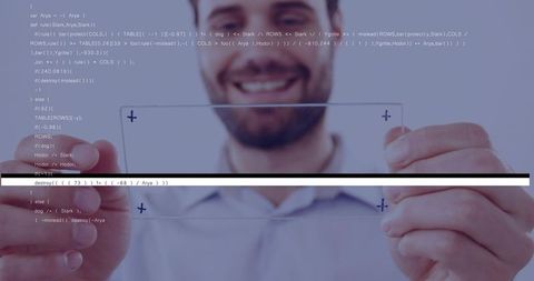 Tech professional aligning transparent glass panels with code overlay, smiling