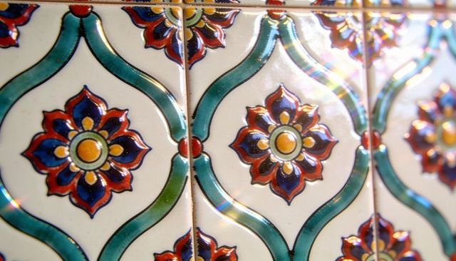 Colorful glazed ceramic tiles featuring floral medallion and turquoise lattice pattern