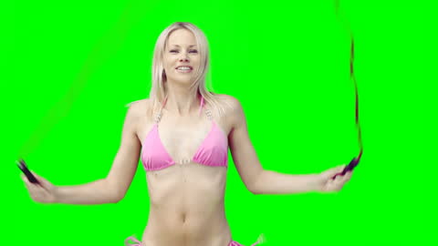 Woman Exercising in Bikini by Skipping Rope with Green Screen