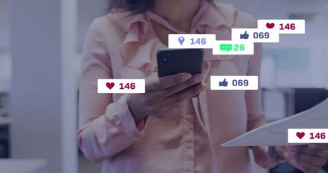 Businesswoman checking smartphone while holding documents with social media notifications