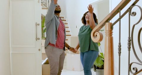 Excited couple exploring new home amid move-in process