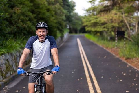 Man Enjoys Outdoor Cycling Adventure on Quiet Urban Road - Download Free Stock Images Pikwizard.com