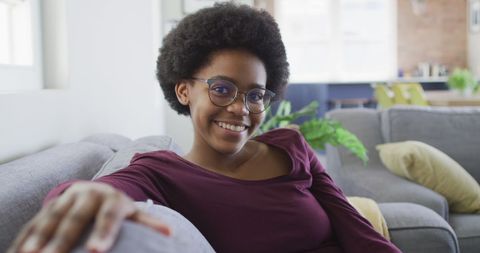 Joyful African American Teen Relaxing on Sofa