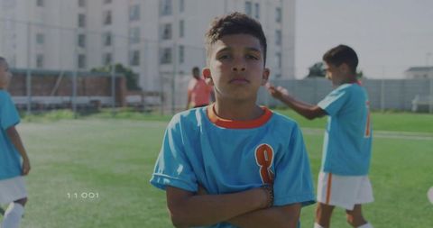 Confident Young Soccer Player Posing on Outdoor Field