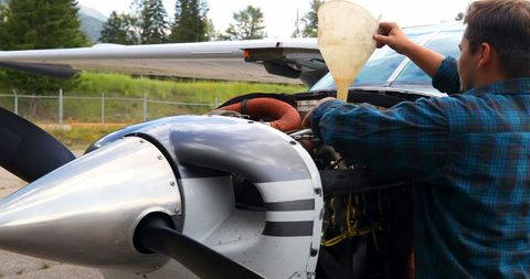Young Mechanic Performing Aircraft Maintenance Outdoors