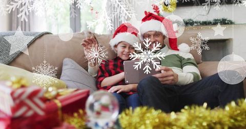 Father and Son Enjoying Christmas Video Call in Festive Living Room