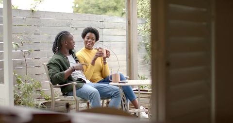 African American Couple Relaxing on Patio with Coffee