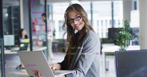 It professional with laptop and code overlays in open-plan office