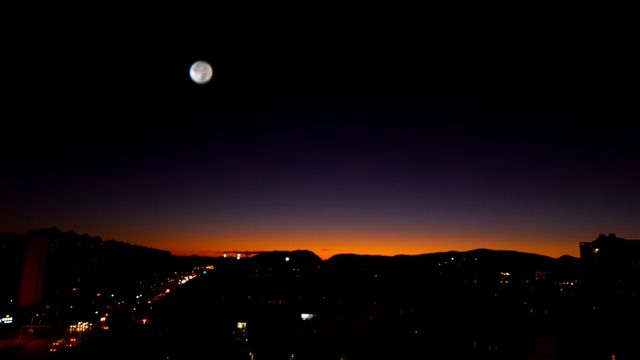 Cityscape Under Night Sky with Moon and Sunset Glow - Download Free Stock Photos Pikwizard.com