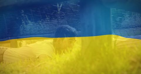 Man Relaxing Under Ukrainian Flag Overlay Outdoors