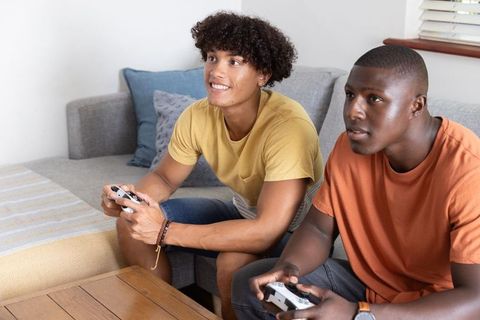 Diverse Friends Engaging in Relaxed Home Gaming Session