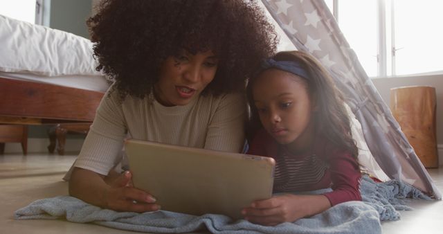 Mother and Daughter Reading Digital Tablet under Blanket Fort - Download Free Stock Images Pikwizard.com