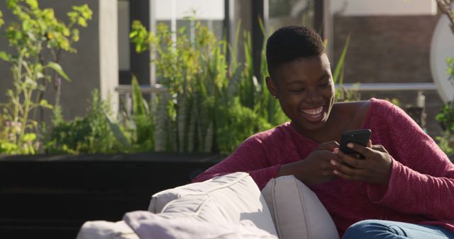 Smiling Woman Texting on Smartphone Sitting Outside on Sunny Day - Download Free Stock Images Pikwizard.com