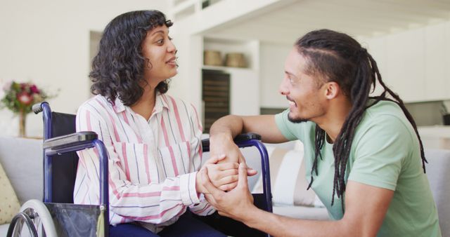 Supportive Male Friend Interacting with Disabled Woman in Wheelchair at Home - Download Free Stock Images Pikwizard.com