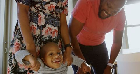 Joyful African American Family Playing with Child at Home