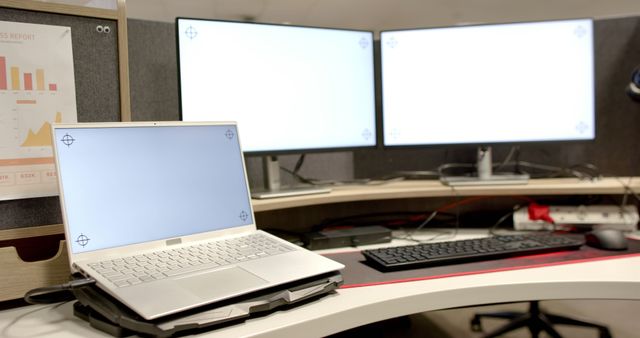 General view of laptop and computers with blank screens in office. Business, work, office, technology concept, copy space.